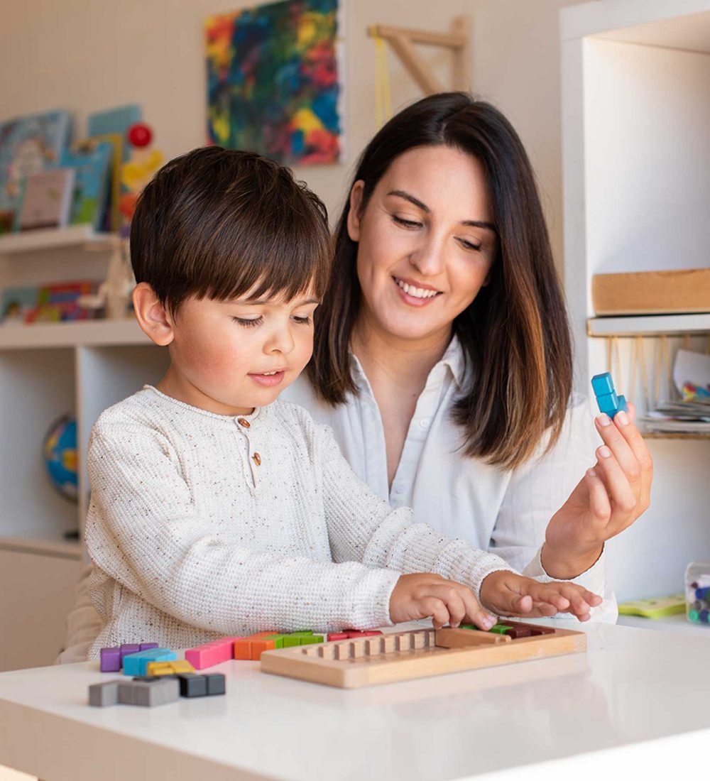 kid-playing-with-a-tetris-wood-puzzle-and-mother-o-2021-09-02-10-31-17-utc.jpg